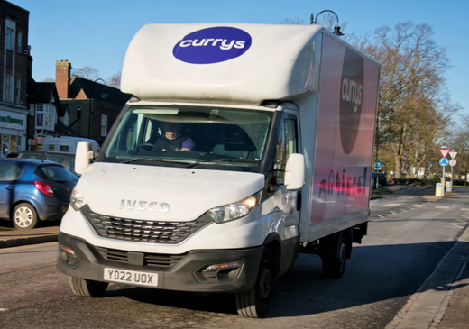 A Currys delivery van on the road