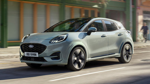 Ford Puma is UK's best-selling vehicle in 2024. Puma driving down a street, slightly blurred due to speed.