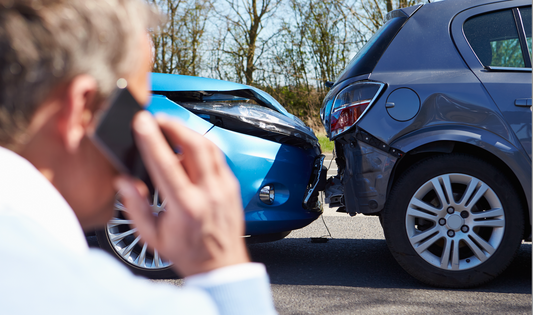 Man on phone reporting car crash